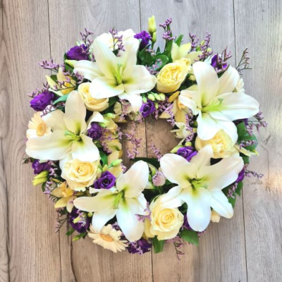 Wreath SYM-317 - A classic wreath arranged using mixed flowers.  Seasonal flowers are selected and bought from the best suppliers all around the world.