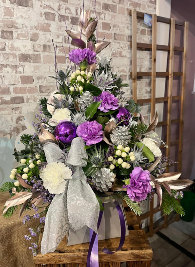 Christmas Sparkle - A luxurious festive arrangement in purple, white and silver tones with seasonal greenery and decorative details, handcrafted by Daisy Chain Florist in Scunthorpe.