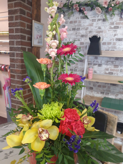 Tropical Summer - A striking arrangement bursting with vibrant yellow, pink, coral and purple tones, handcrafted by Daisy Chain Florist in Scunthorpe.