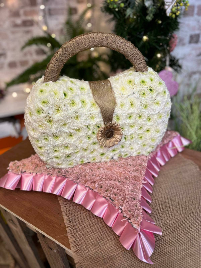 Hand bag funeral tribute - Handbag funeral tribute: a fun way to honor a friend or loved one. The bag measures 1ft long and sits on a base at least 1.5 ft wide.