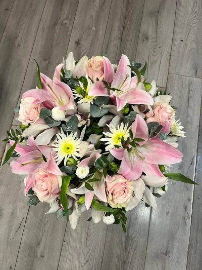 Lily and rose wreath ring - This gorgeous lily and rose wreath in pink, white, and green tones, with flowing, wispy greenery and trailing eucalyptus, is the perfect way to say goodbye to a loved one.