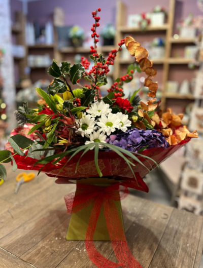 Winter Woodland Bouquet - A beautiful seasonal arrangement featuring rich reds, crisp whites and touches of purple, complemented by festive foliage. Handcrafted by Daisy Chain Florist in Scunthorpe.