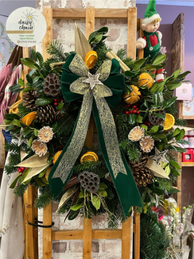 Festive Evergreen Wreath - A beautiful Christmas wreath featuring lush seasonal foliage, pine cones, dried oranges and festive berries. Handcrafted by Daisy Chain Florist in Scunthorpe.